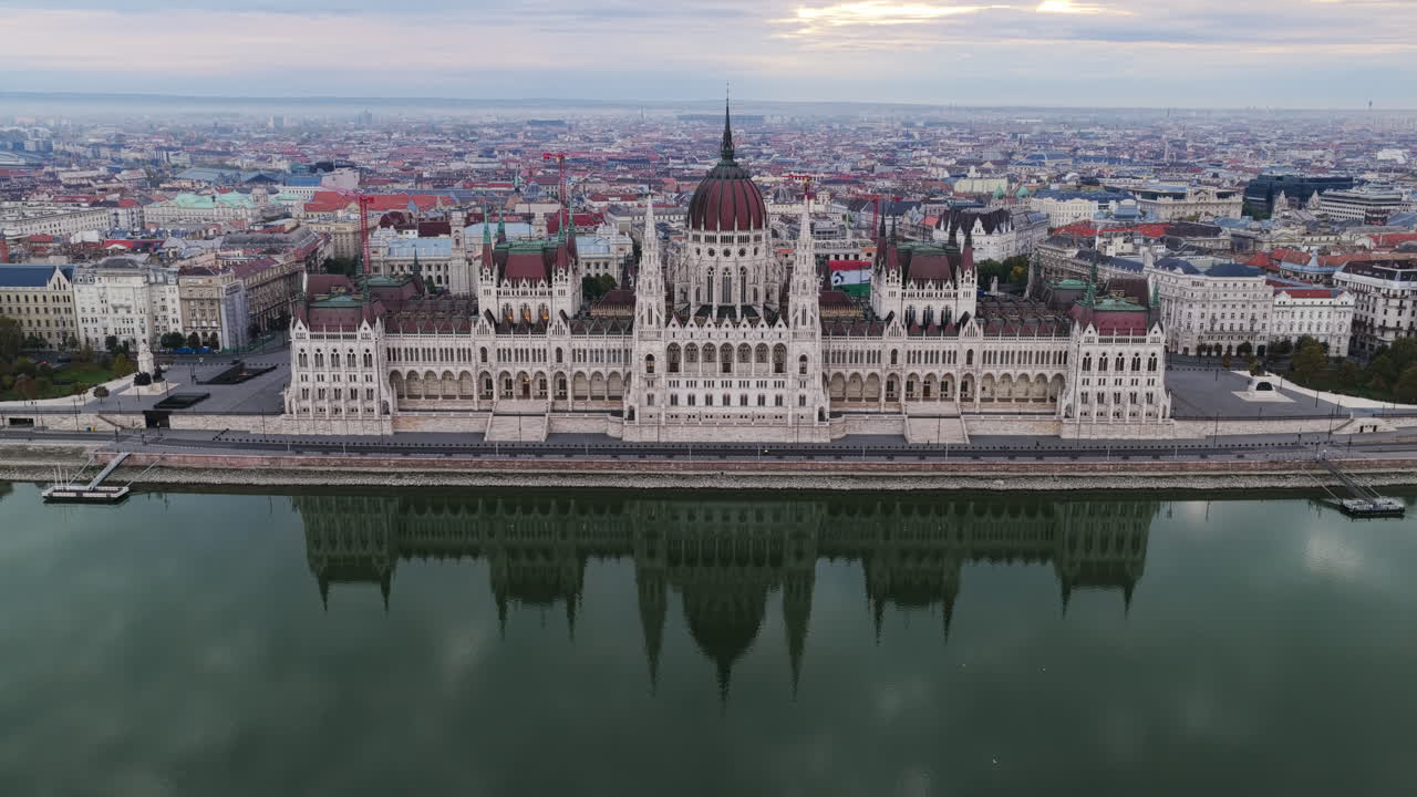 The Hungarian Parliament stands proudly along the Danube, its Gothic Revival towers mirrored in still waters below
