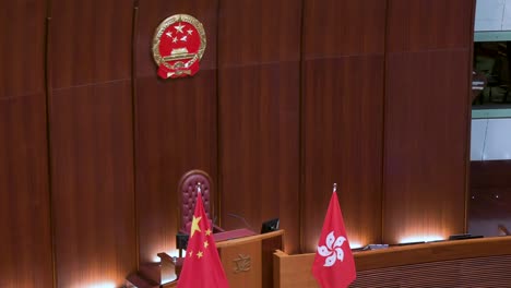 View-of-the-the-Chinese-emblem-is-seen-above-the-People's-Republic-of-China-flag-at-the-main-chamber-at-the-Legislative-Council-building-known-as-Legco-in-Hong-Kong