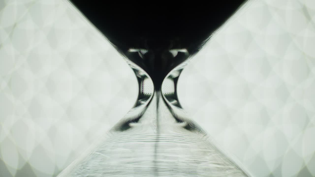 Transparent sand clock pouring sand