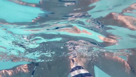 Underwater-view-of-woman-swimming-in-the-pool