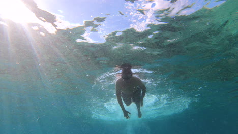 Swimming-in-the-blue-ocean-in-Playa-Chen-Rio,-Cozumel-island,-Riviera-Maya,-Mexico