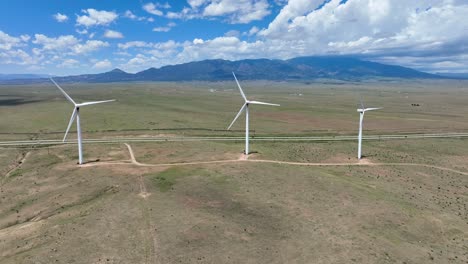 three wind turbines on wind farm in mountainous region in usa