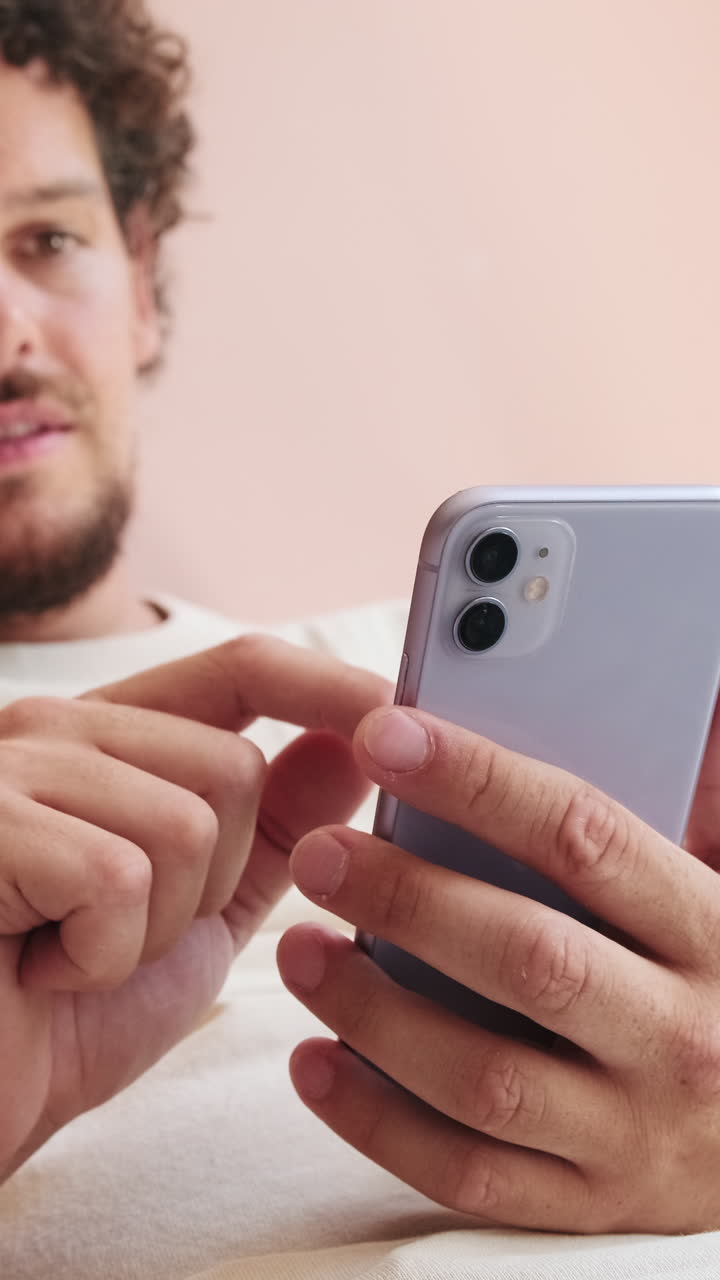 Young Man Scrolling and Swiping on a Smartphone