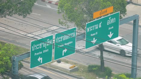 thai road signage directions at huai khwang district from an above angle perspective in bangkok, thailand in 4k dci