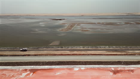 salt flats aerial view with road and vehicle