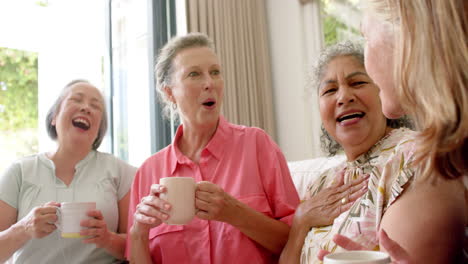 senior diverse group of women share a joyful moment over coffee