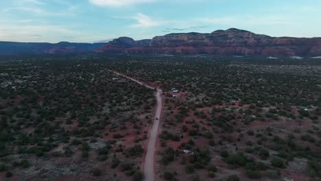 panoramic view of a road surrounded with green shrubs near sedona red rocks in arizona