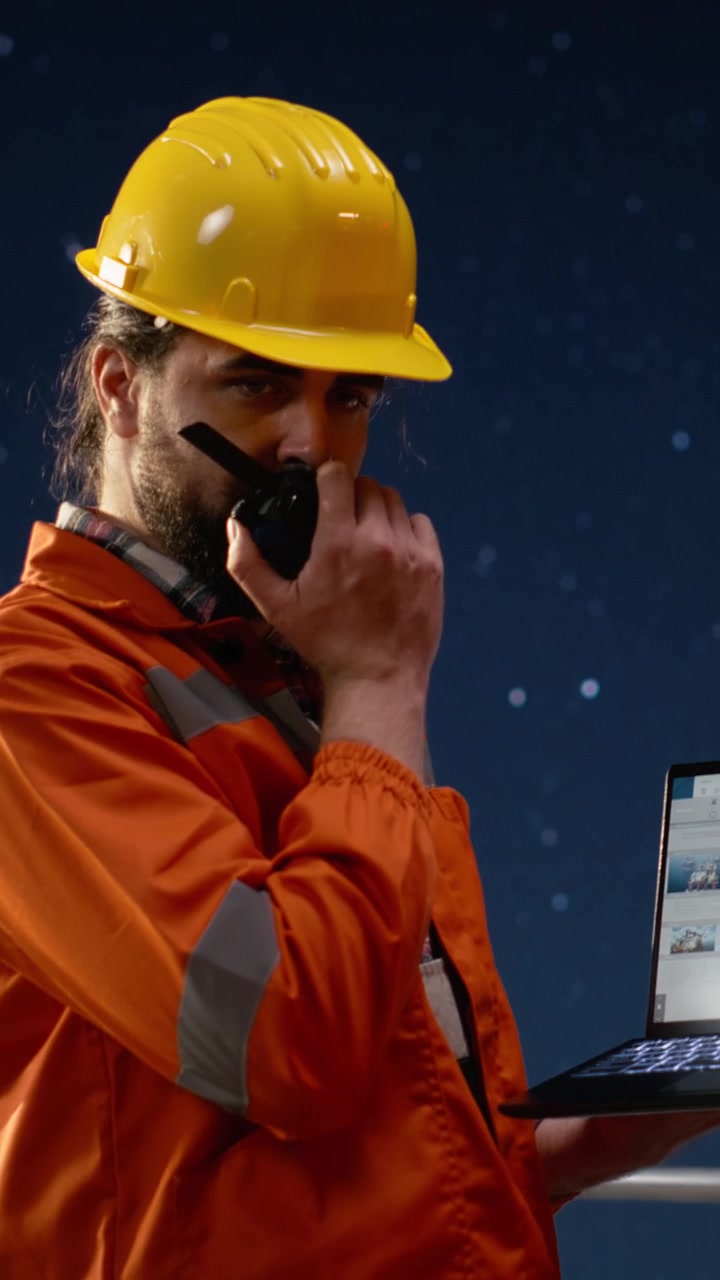 Video verticale. Squadra su chiatta di perforazione che usa un laptop per monitorare malfunzionamenti durante la crisi petrolifera.