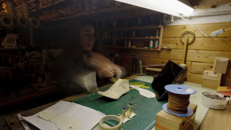 time lapse female craftsperson working in small business workshop making custom footwear with last at workbench