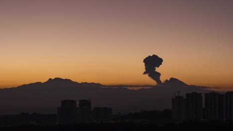 time lapse of iztaccihuatl and popocatepetl active volcano with eruption and fumarole during the golden hour, before sunrise from the financial zone of santa fe, in mexico city