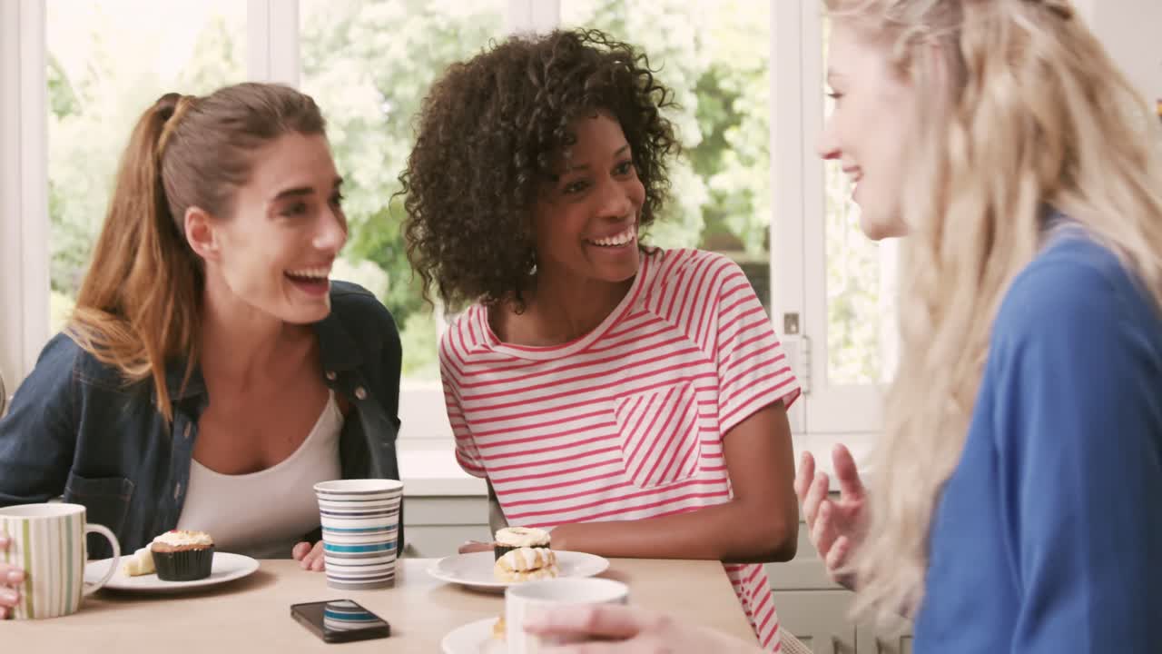 Happy friends eating pastries and drinking coffee