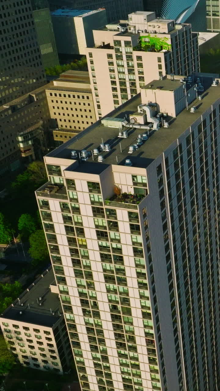 Multi-storied building and skyscrapers of New York city. Top view on the residential area with green streets. Vertical video