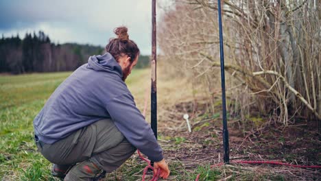 man constructing skigard traditional fence in norway - close up
