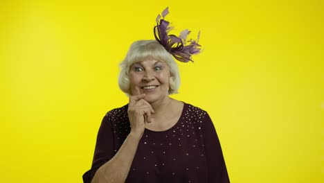 senior old woman with happy meditative expression, fantasizing, thinking, making positive idea