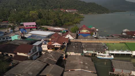 Slow-reverse-aerial-shot-of-boats-and-structures-along-the-Bang-Bao-pier-in-Koh-Chang,-Thailand