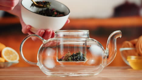 preparing loose leaf tea in a glass teapot