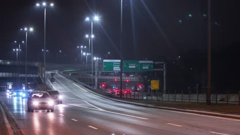 timelapse traffic interchange road in evening, modern roadway intersection in warsaw city at night. cars driving junction highway in fast motion. multilevel expressway shot in time-lapse