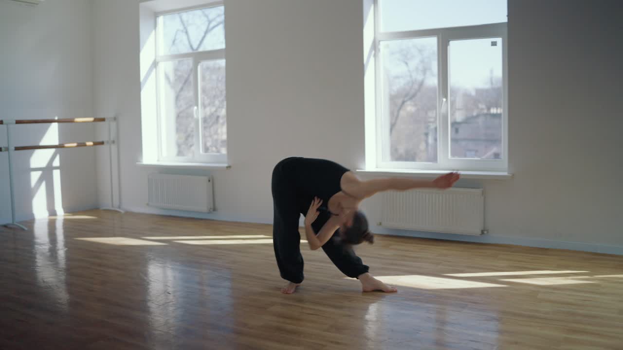 A woman dances in a studio