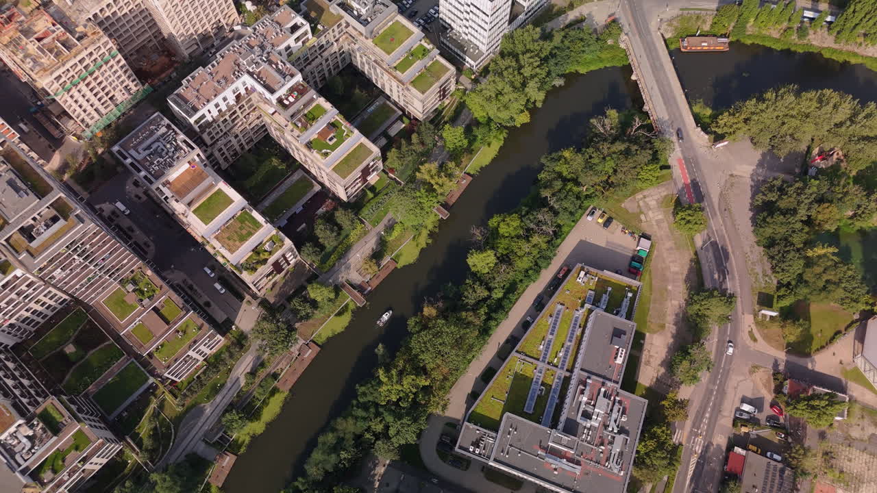 Aerial view of a city with a canal and rooftop gardens