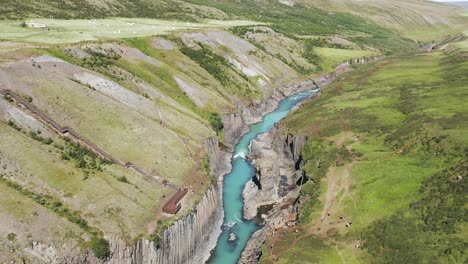 Tourist-enjoy-scenic-basalt-rock-formations-with-blue-river-at-Studlagil