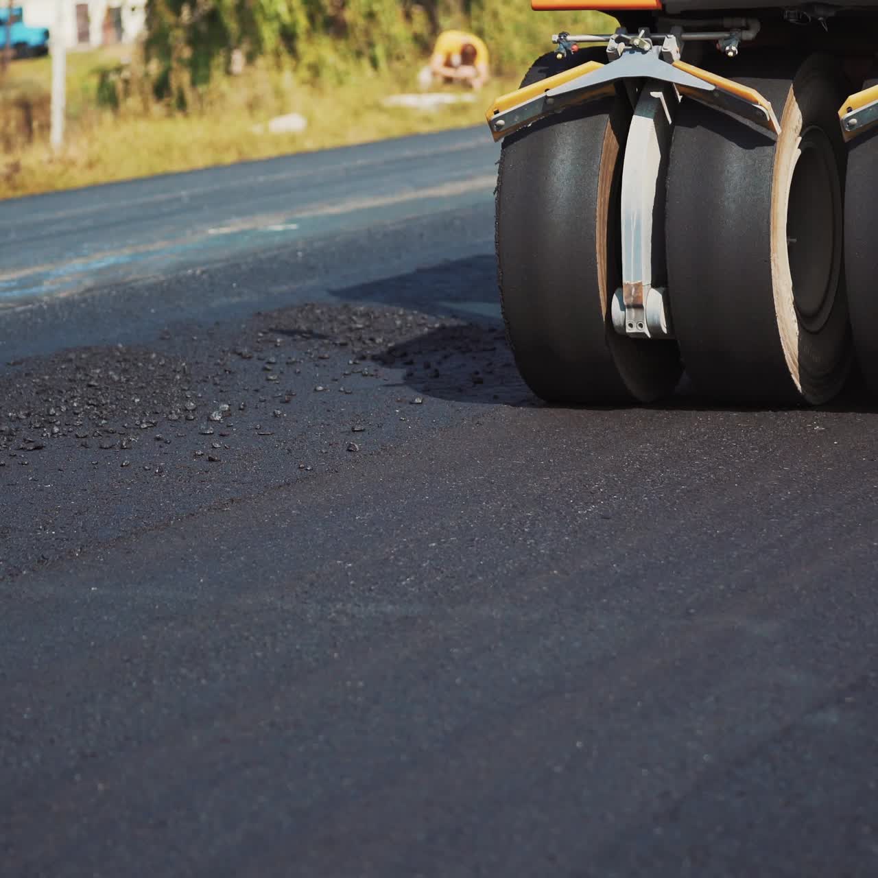 Paving machine placing a layer of asphalt