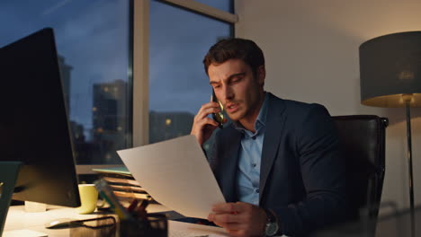 entrepreneur working night office alone. successful lawyer analyst talking phone