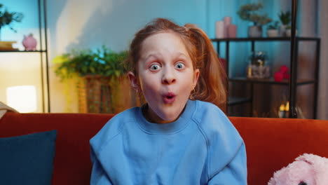 excited girl child kid surprised shocked by sudden victory good win news celebrating wow reaction