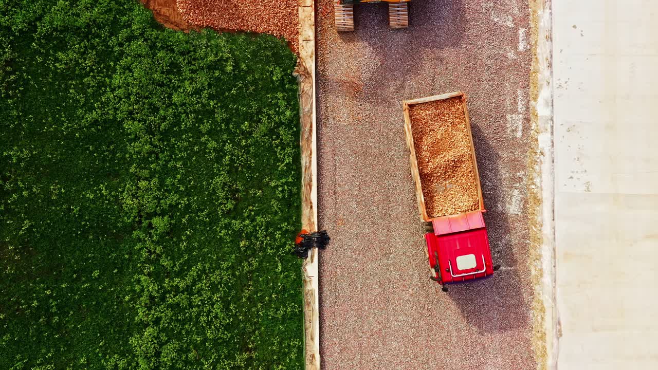 Overhead Drone View of Excavator and Dump Truck Spreading Breakstone on Rail Bed Slope