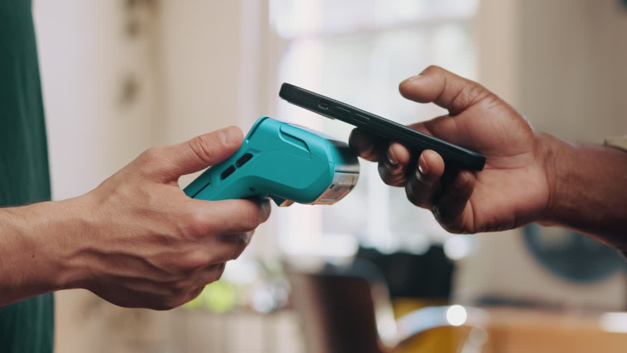 Close-up of Hands Making Contactless Payment with Smartphone on POS Terminal