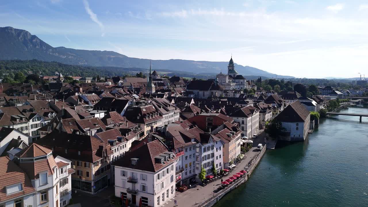 Cityscape with River and Mountains