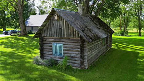 rustic wooden log cabin at the green lawn yard. pullback shot