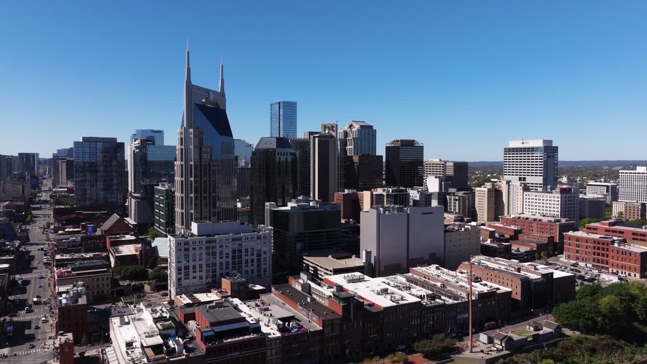 Drone Ascends Above Downtown Nashville City on Sunny Day