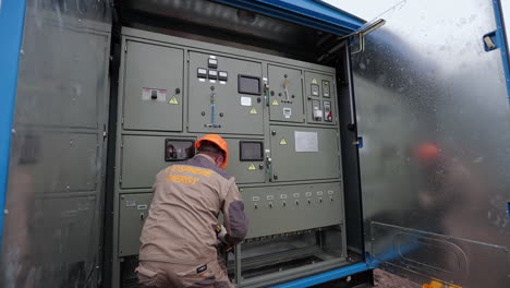 electrical technician working on a control panel