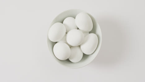 Close-up-of-bowl-of-white-eggs-with-copy-space-on-white-surface