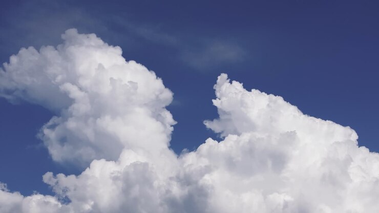 Fluffy White Clouds Against Blue Sky