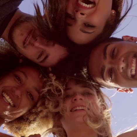 low angle view of five friends in a huddle