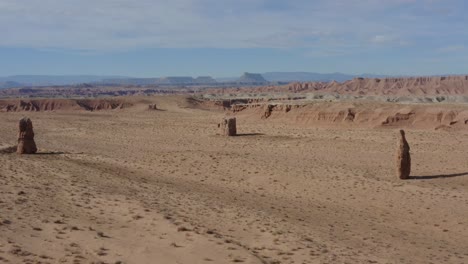 drone shot flying towards some unique rock pillars in the southern utah desert