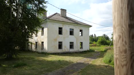 toma en cámara lenta de una casa blanca abandonada en un pueblo solitario