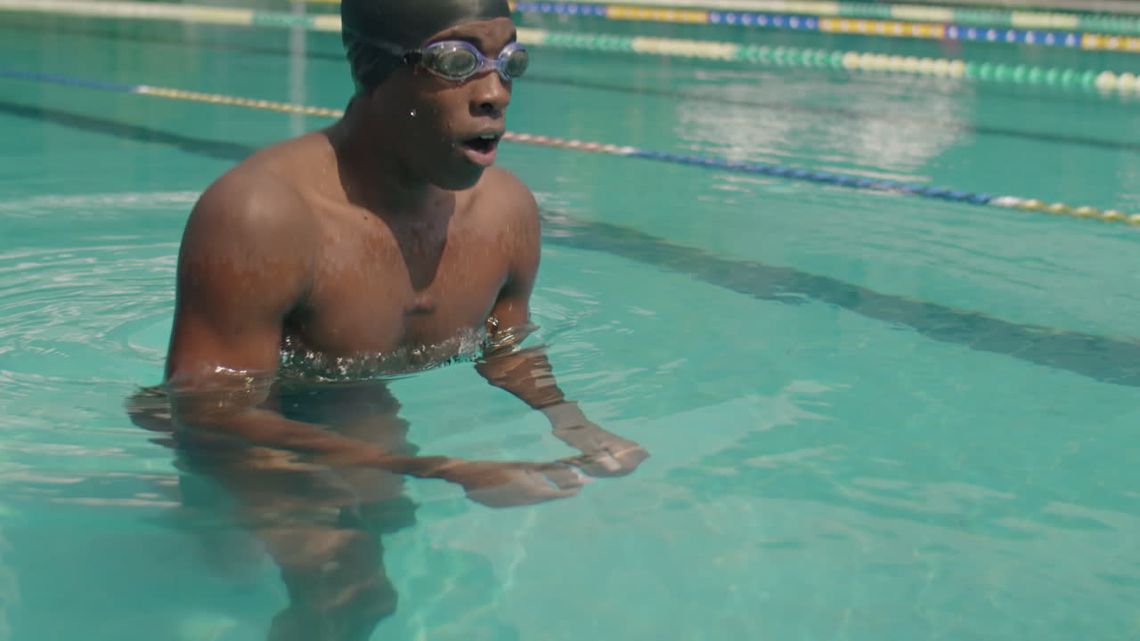 Black Swimmer Practicing Breaststroke in Outdoor Pool