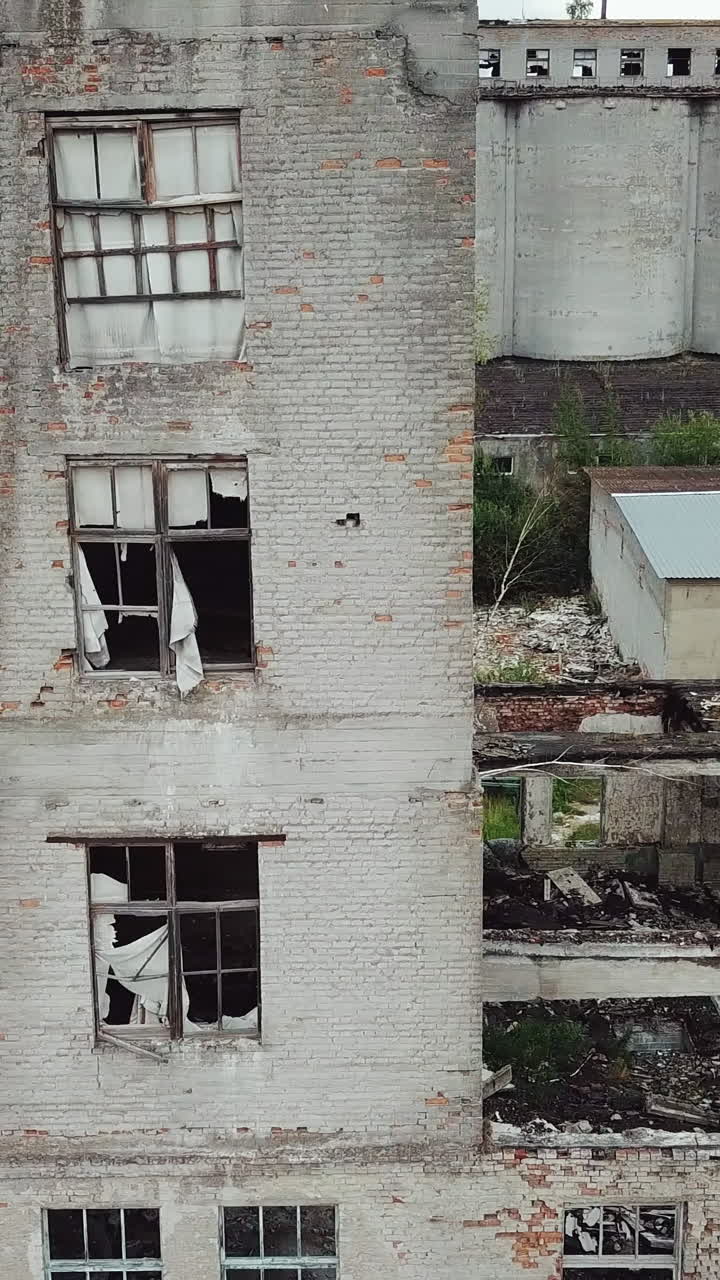 Old abandoned factory building. Aerial View. Vertical video