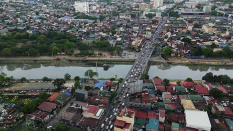 aerial forward shot of bustling traffic on marikina bridge during rush hour – marikina city, philippines