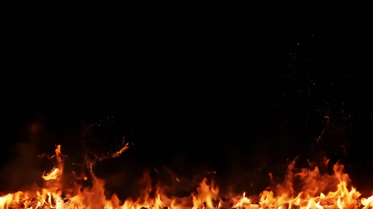 Low-angle video capturing vibrant flames against a dark background, emphasizing the dynamic movement
