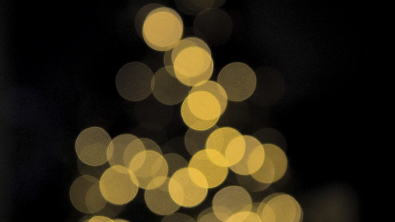 Yellow, bokeh lights of defocused christmas tree background