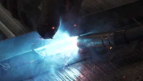 welder works in metal construction - construction and processing of steel components, slow motion