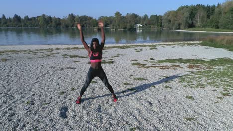 Drone-shot-of-young-attractive-black-female-doing-sports-outdoors