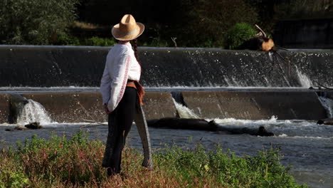 Romanian-girl-visits-dam-waterfall-in-Bant,-Romania-1