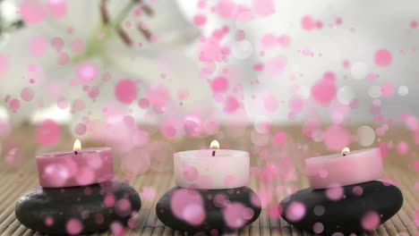 animation of candles on pebbles surrounded by pink bubbles