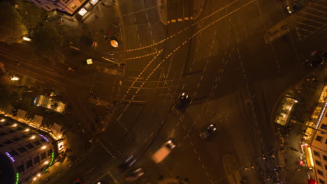 Beautiful-Drone-Time-Lapse-Hyper-Lapse-of-Busy-Intersection-at-night-in-Berlin,-Germany-with-city-lights-on-Rosenthaler-Platz,-Aerial-Birds-Eye-Top-Down-Overhead-View,-Hyperlapse