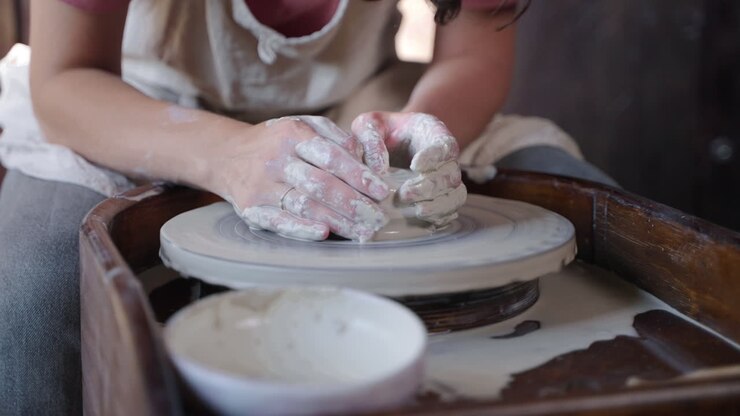 Woman Shaping Clay on a Pottery Wheel