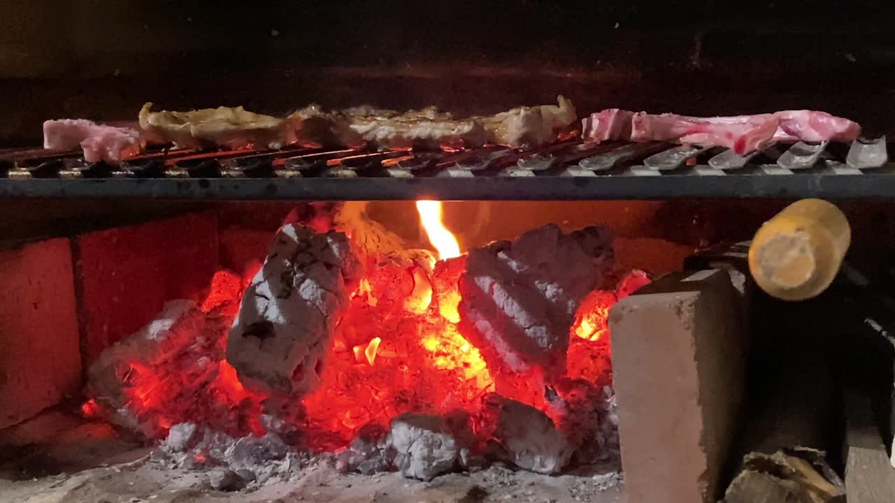 Ribs roasting in a barbecue with fire.